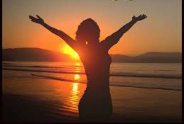 woman in white long sleeve shirt covering her face with her hands