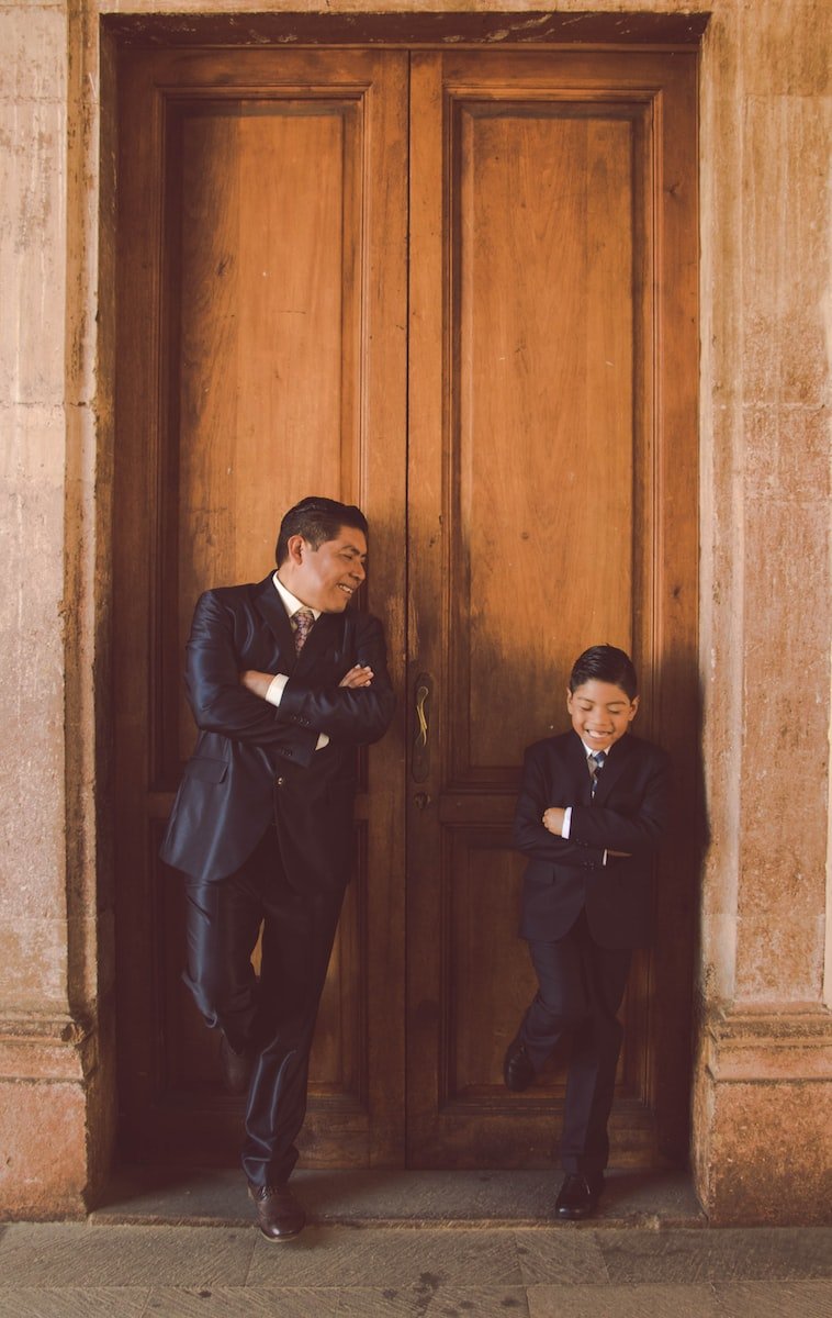 man in black suit standing beside man in black suit